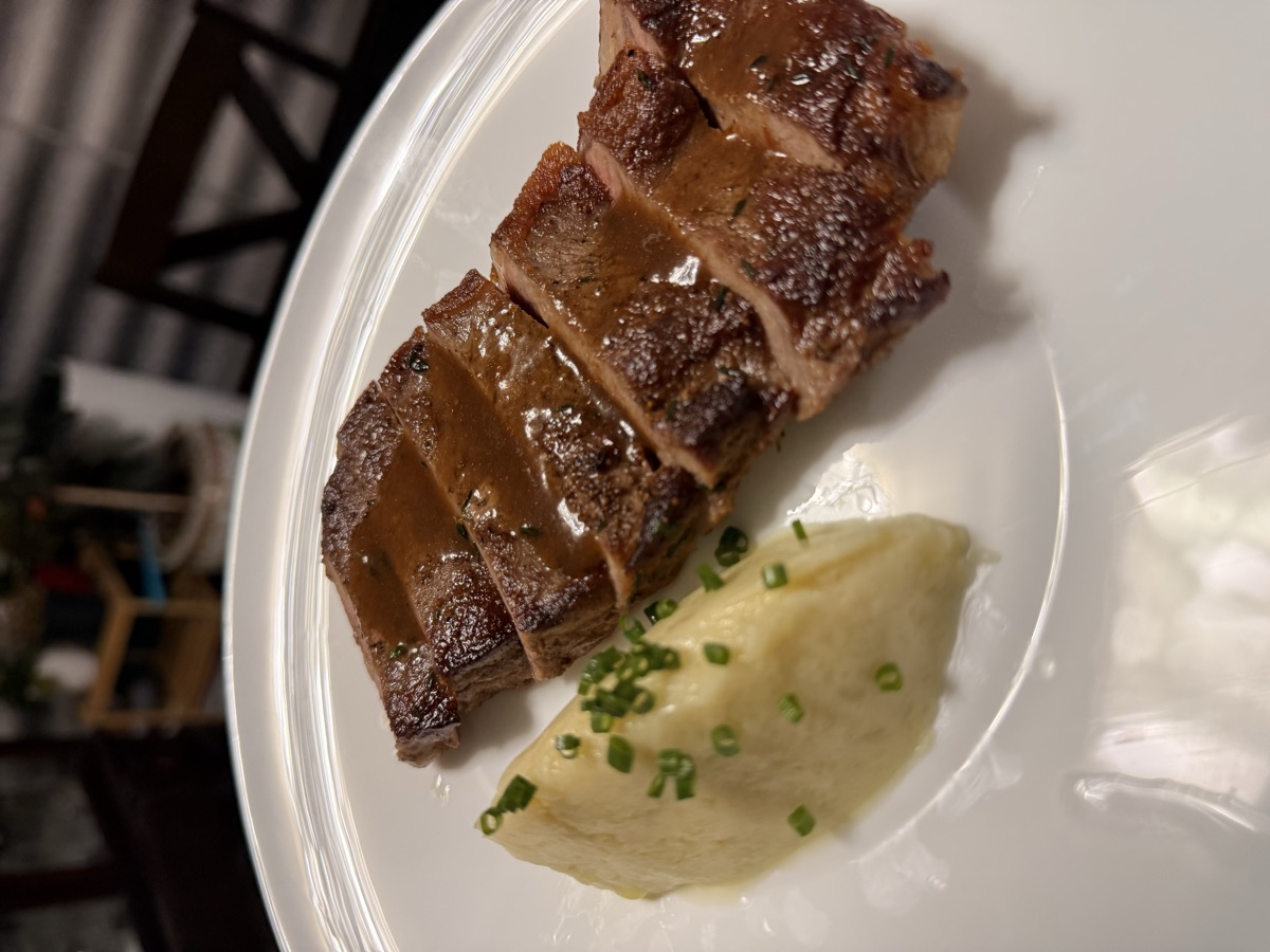 Sliced glazed duck with chive mashed potato