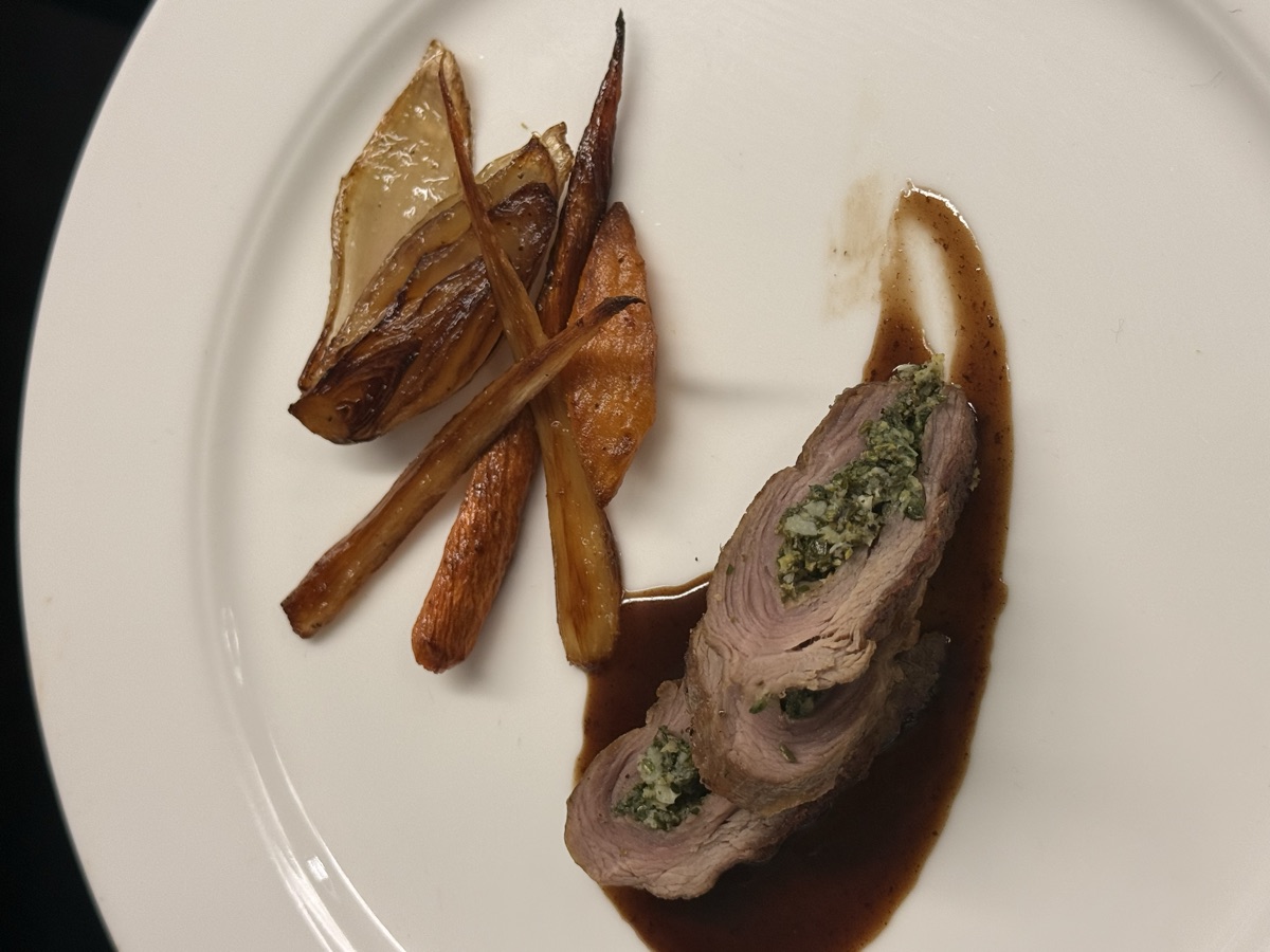 Herb-stuffed meat roulade with roasted carrots and fennel